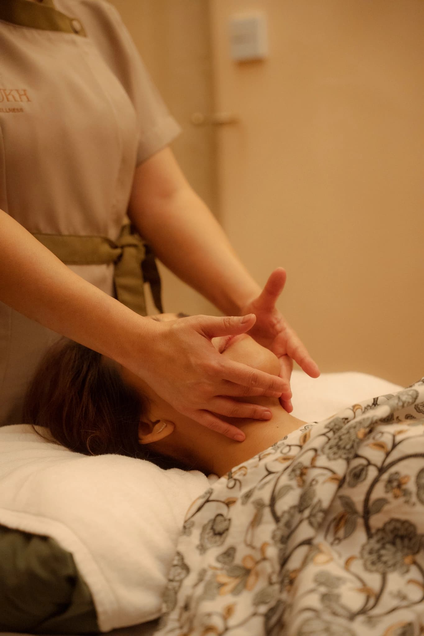 A therapist working on a guest's neck and shoulders during a massage